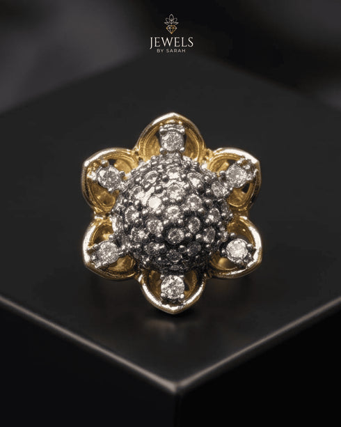 "Two-tone domed crystal ring with gold floral border on dark surface by Jewels by Sarah"