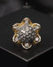 "Two-tone domed crystal ring with gold floral border on dark surface by Jewels by Sarah"