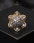 "Two-tone domed crystal ring with gold floral border on dark surface by Jewels by Sarah"