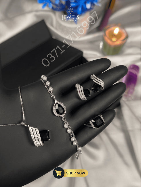 Midnight black stone designer jewelry set with silver pave detailing.