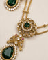 Close-up of South Indian emerald pendant with bird motif and teardrop stone in 22K gold polish - Jewels by Sarah