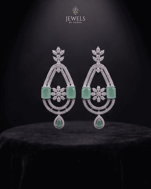 Mint green AD stone chandelier earrings on black background