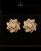 "Swirling crystal floral stud earrings with two-tone gold finish on black velvet by Jewels by Sarah"