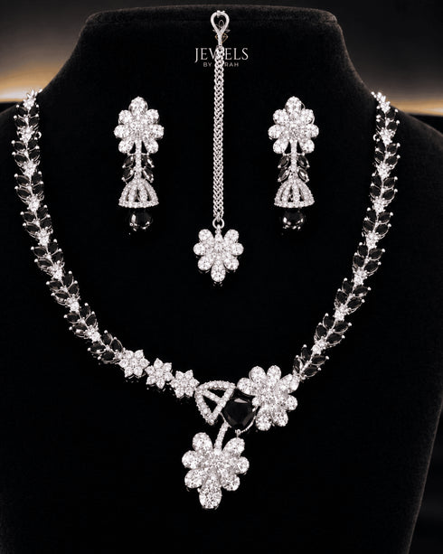 "Black American diamond necklace set with matching tikka and earrings on display"