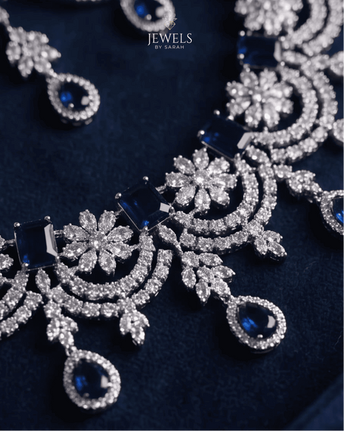 Close up of sapphire blue AD stone necklace with floral silver detailing