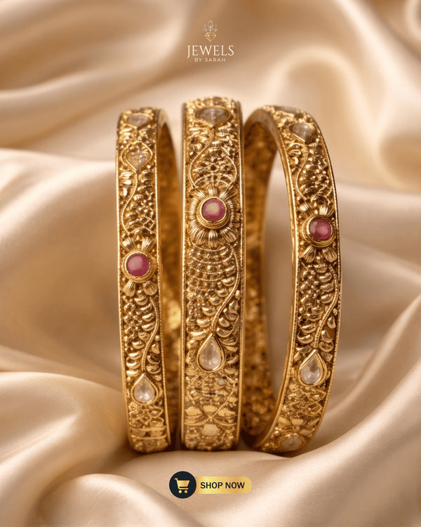 Trio of Jewels by Sarah 24K gold plated signature bangles with ruby zircons on gold silk.