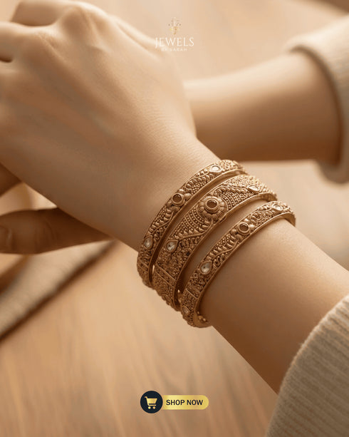 Lifestyle shot of Jewels by Sarah signature bangles paired with a luxury silk ensemble.