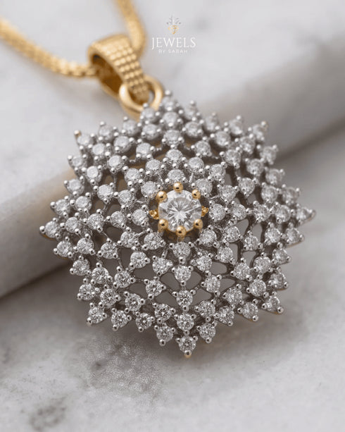 "Close-up of diamond-cut jurao stone snowflake pendant in 22K gold polish by Jewels by Sarah"