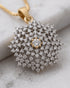 "Close-up of diamond-cut jurao stone snowflake pendant in 22K gold polish by Jewels by Sarah"