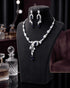 "Sapphire blue AD swirl necklace set with curved earrings on display bust by Jewels by Sarah"