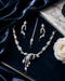 "Sapphire blue AD swirl necklace set with tikka and earrings on navy velvet by Jewels by Sarah