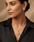 "Model wearing 22K gold polish jurao stone necklace and earrings styled with black shirt"