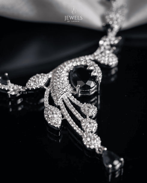 "Close-up of original AD stones and sapphire centerpiece on silver polish swirl necklace"