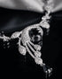 "Close-up of original AD stones and sapphire centerpiece on silver polish swirl necklace"