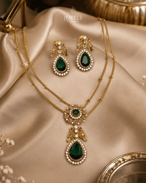 South Indian emerald peacock necklace set with matching earrings on satin fabric - Jewels by Sarah Signature Collection