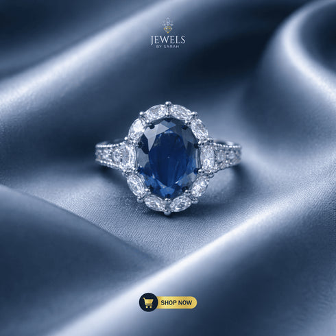 Signature Royal oval sapphire blue ring with marquise halo on blue silk