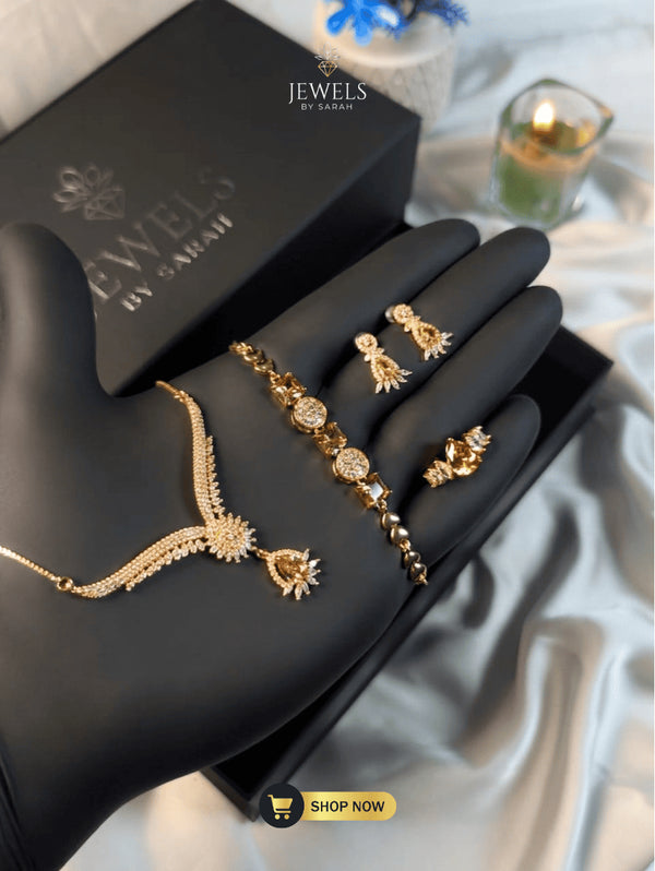 Gold-plated luxury formal jewelry set including crown ring and bracelet.