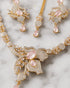 "Close-up of mint pink stone and AD crystal butterfly pendant on golden necklace set"