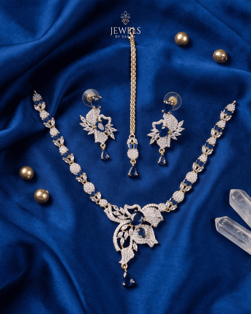 "Gold-tone butterfly necklace set with royal blue stones and gold pearls on blue satin by Jewels by Sarah"