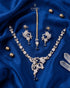 "Gold-tone butterfly necklace set with royal blue stones and gold pearls on blue satin by Jewels by Sarah"