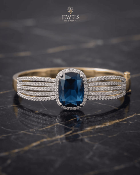Sapphire blue zircon statement bangle bracelet on dark marble – Jewels by Sarah