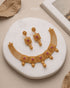 South Indian antique gold choker and earring set on marble tray