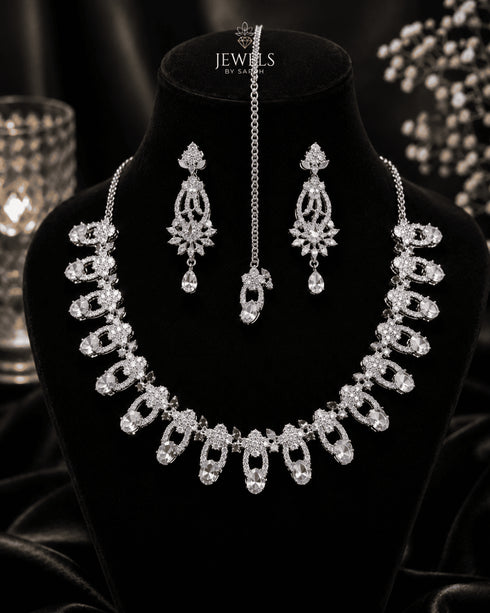 "Silver white AD scalloped necklace set with tikka and earrings on display bust by Jewels by Sarah"