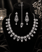 "Silver white AD scalloped necklace set with tikka and earrings on display bust by Jewels by Sarah"