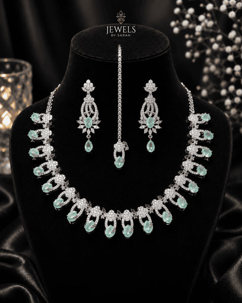 "Mint green AD scalloped necklace set with tikka and earrings on display bust by Jewels by Sarah"