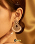 Close-up of a model wearing radiant Zircon floral chandbali earrings with delicate pearl detailing.