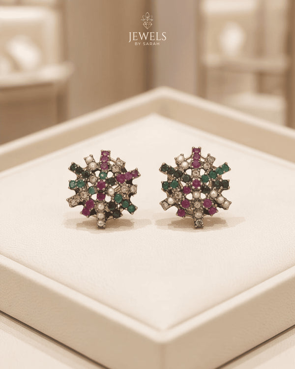 22K gold plated multi color stone stud earrings on beige jewelry box