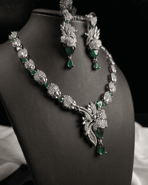 "Emerald green feather AD necklace set with earrings on display bust by Jewels by Sarah"