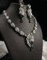 "Emerald green feather AD necklace set with earrings on display bust by Jewels by Sarah"