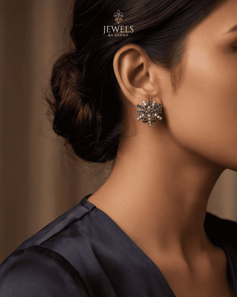 Multi color stone stud earring worn on model ear with black outfit