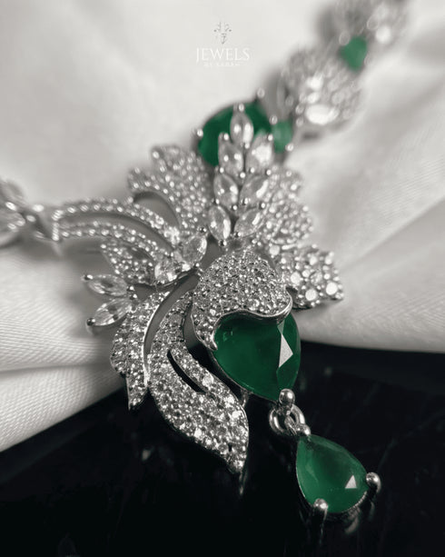"Close-up of emerald green stones and feather pendant design on AD necklace by Jewels by Sarah"
