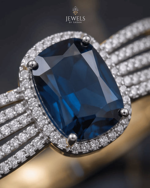 Close-up of sapphire blue center stone with pave zircon halo – Jewels by Sarah