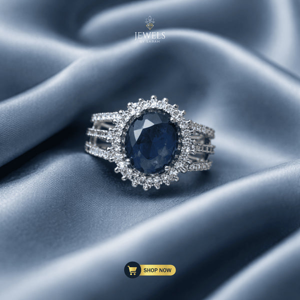 Signature oval sapphire blue halo ring on luxury silk by Jewels by Sarah