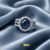 Signature oval sapphire blue halo ring on luxury silk by Jewels by Sarah