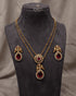South Indian ruby peacock necklace set with matching earrings displayed on mannequin bust - Jewels by Sarah