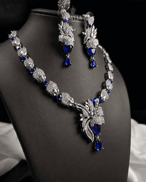 "Sapphire blue feather AD necklace set with earrings on display bust by Jewels by Sarah"