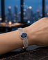Woman wearing sapphire blue zircon statement bangle with city view – Jewels by Sarah