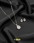 Baby pink teardrop pendant necklace and matching stud earrings on black silk.