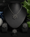The complete luxury midnight black signature collection suite featuring the necklace, earrings, and ring arranged on a professional black jewelry display stand