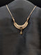 Rose gold filigree crescent necklace with midnight black stone floral center and matching black teardrop dangle.