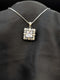 Silver-plated necklace featuring a brilliant clear square cushion-cut pendant surrounded by a white cubic zirconia floral halo on a black background.