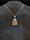 Rose gold necklace featuring a rectangular champagne-colored stone pendant with a crystal halo and a butterfly-shaped stone bail on a black background.