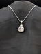 Silver-plated necklace featuring a brilliant clear cushion-cut square pendant with a micro-pavé stone halo on a black background.