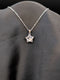Silver-toned stainless steel star pendant necklace with a large round crystal center on a black background.