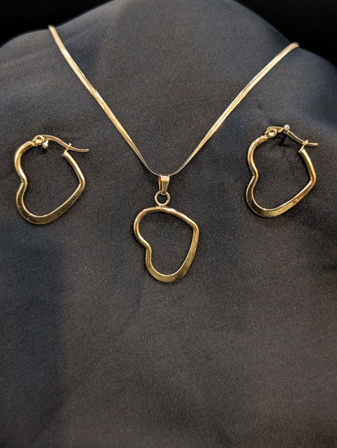 Gold-plated stainless steel jewelry set featuring an asymmetrical open-heart pendant on a snake chain and matching heart-shaped hoop earrings.
