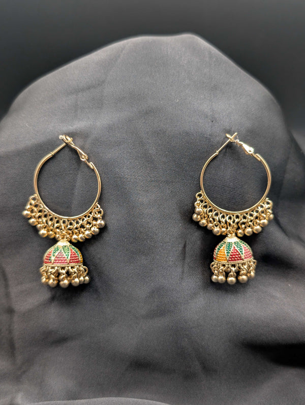 Gold-toned hoop earrings featuring a central Jhumka bell with multi-color enamel work and a beaded fringe on a dark fabric background.